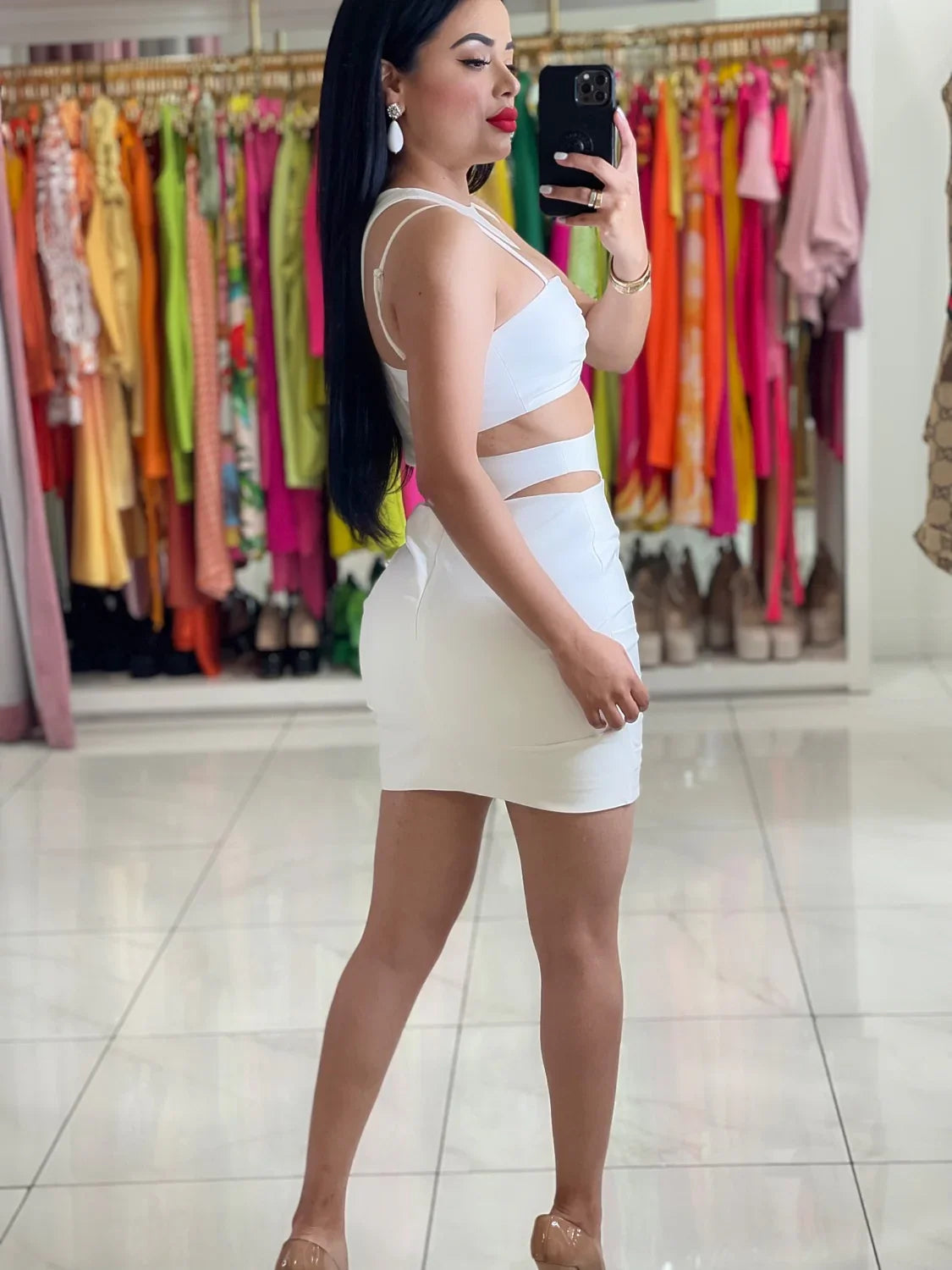Shely white polyester mini dress with back zipper, adjustable straps, and waist cutouts.