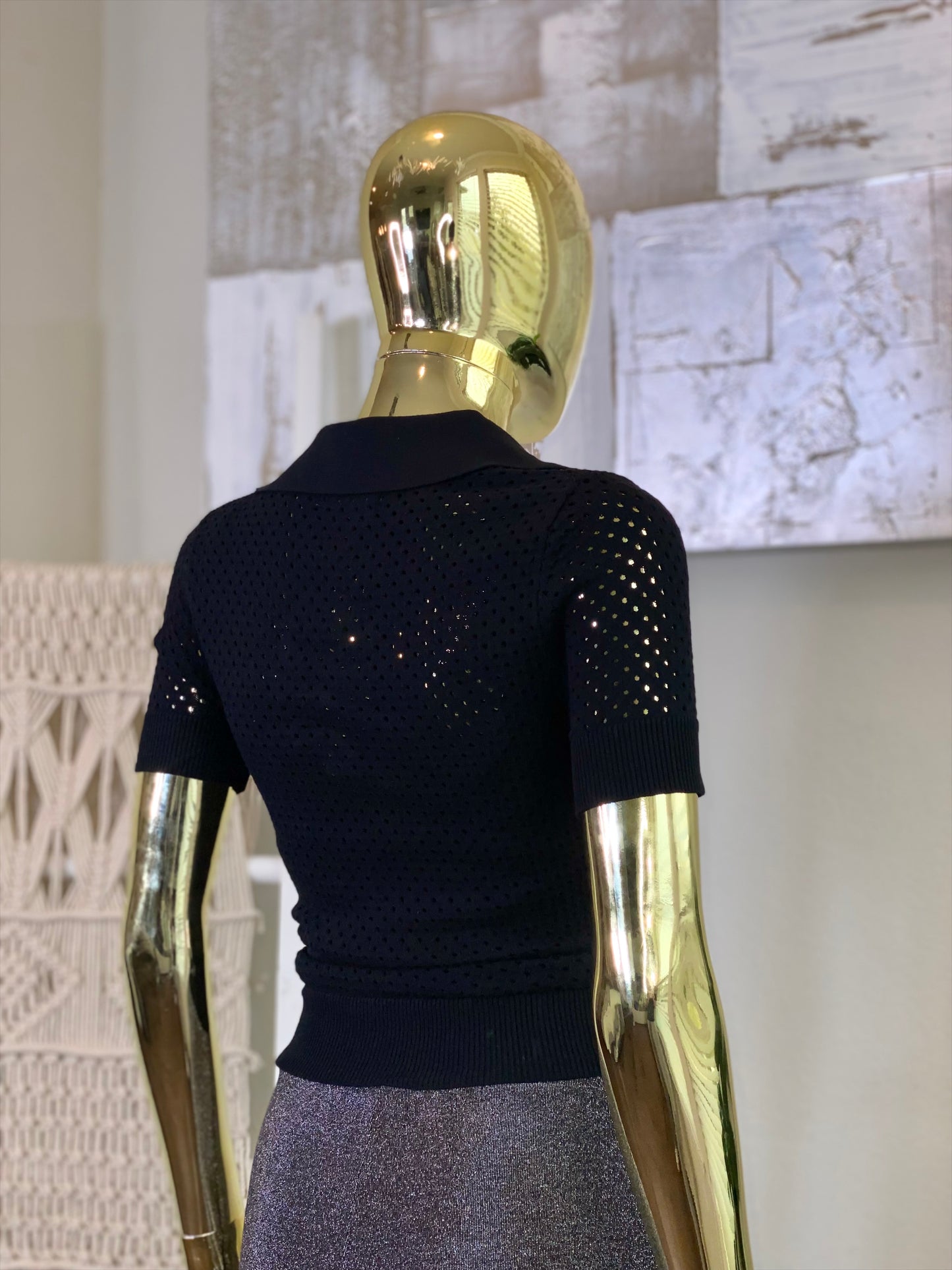 Black Stones Crochet Shirt, a black crochet top with rhinestones, on a gold mannequin.