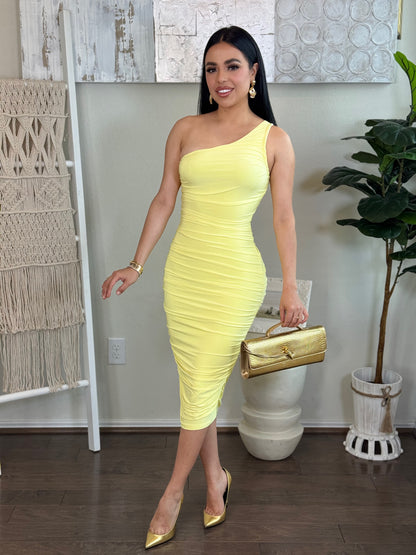 Women's solid yellow scrunchy midi dress with one shoulder, made from stretch material.