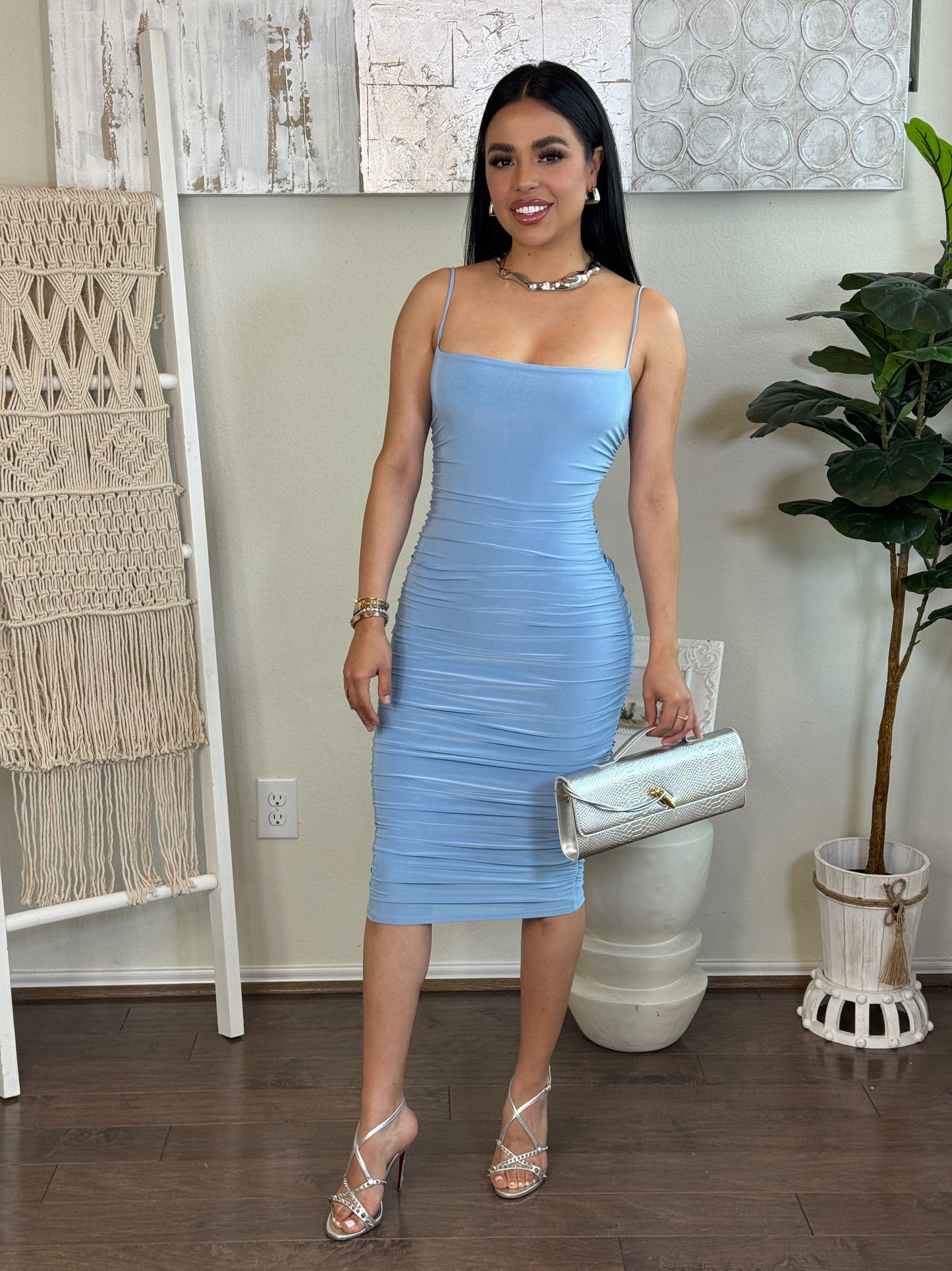 Sky Dress: Solid light blue scrunchy mini dress with spaghetti straps, worn by a model.